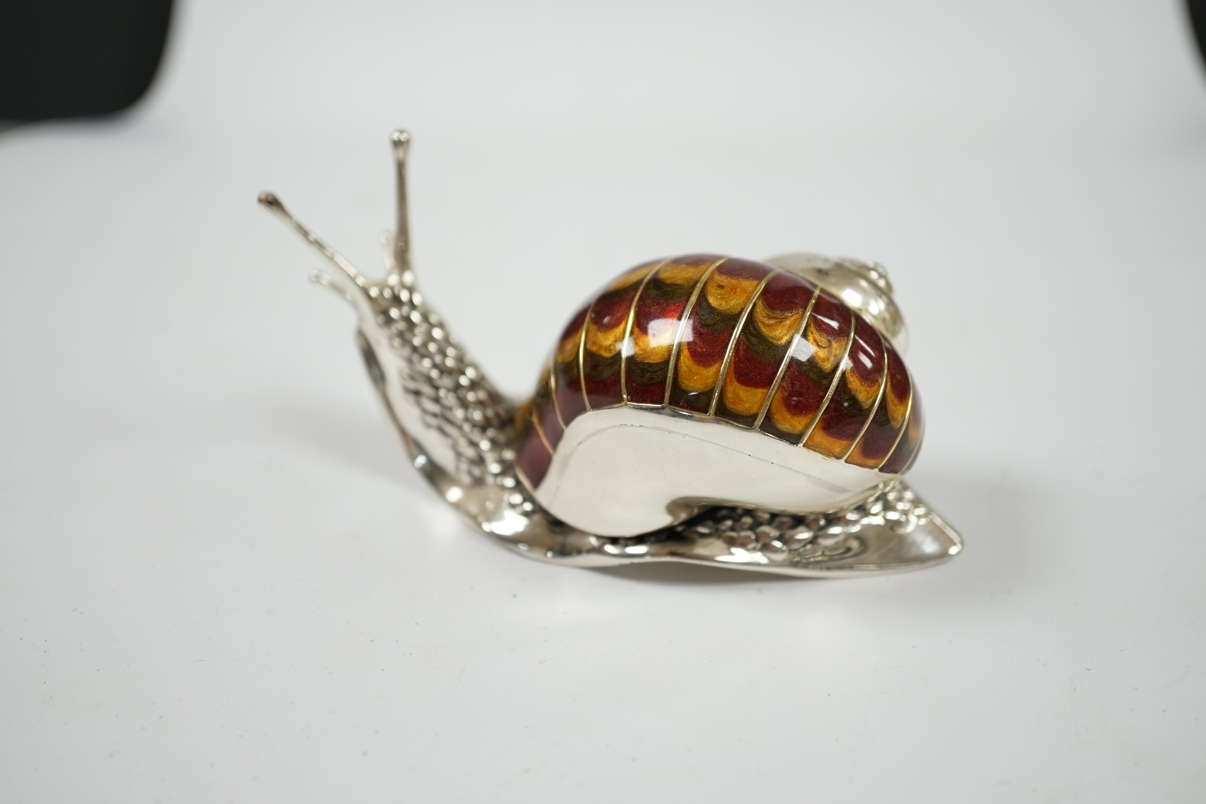 A Saturno silver and enamel model of a snail, by Francis Howard, length 10cm, gross weight 5oz. Condition - good